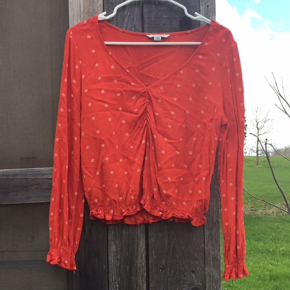 Red blouse with flower detail